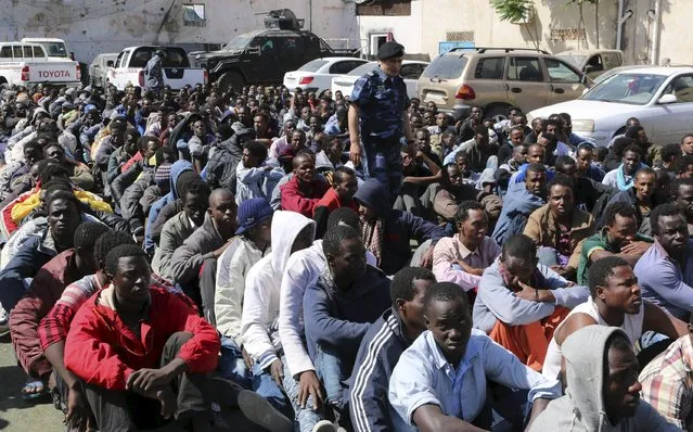 Migrants sit at a detention center after they were detained by the Libyan authorities in Tripoli, Libya May 17, 2015. (Photo by Hani Amara/Reuters)