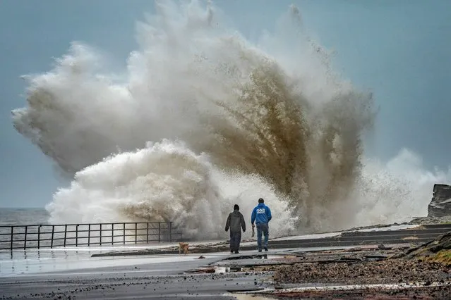 Huge waves hit the promenade at Whitley Bay, North Tyneside, England late Monday afternoon, March 11, 2024, with some people braving a walk along the seafront. (Photo by Ian Sproat/Picture Exclusive)