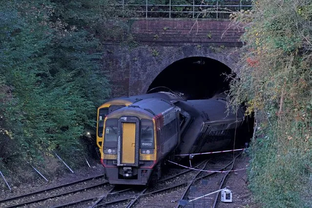 The scene of a crash involving two trains near the Fisherton Tunnel between Andover and Salisbury in Wiltshire, England early Monday, November 1, 2021. Two passenger trains crashed after one of them derailed in the southern English city of Salisbury, and several people were injured, authorities said Sunday. (Photo by Steve Parsons/PA Wire via AP Photo)