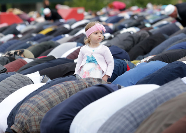 A girl is seen as Albanian Muslims attend the morning prayers of Eid al-Fitr, marking the end of the holy month of Ramadan in Skanderbeg square Tirana, Albania on June 4, 2019. (Photo by Florion Goga/Reuters)