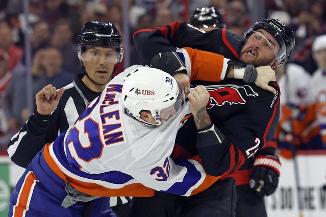 Carolina Hurricanes' Stefan Noesen (23) exchanges blows with New York Islanders' Kyle MacLean (32) during the first period in Game 2 of an NHL hockey Stanley Cup first-round playoff series in Raleigh, N.C., Monday, April 22, 2024. (Photo by Karl B DeBlaker/AP Photo)