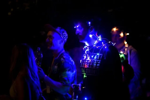 Revellers are lit up as night falls during the Glastonbury Festival at Worthy Farm in Somerset, Britain, June 25, 2015. (Photo by Dylan Martinez/Reuters)