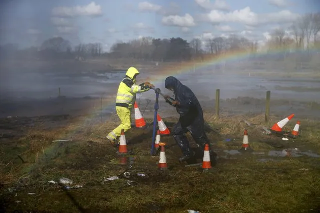 A rainbow forms as workers try to shut down a burst watermain in Halewood, in Liverpool, Britain March 31, 2016. (Photo by Phil Noble/Reuters)