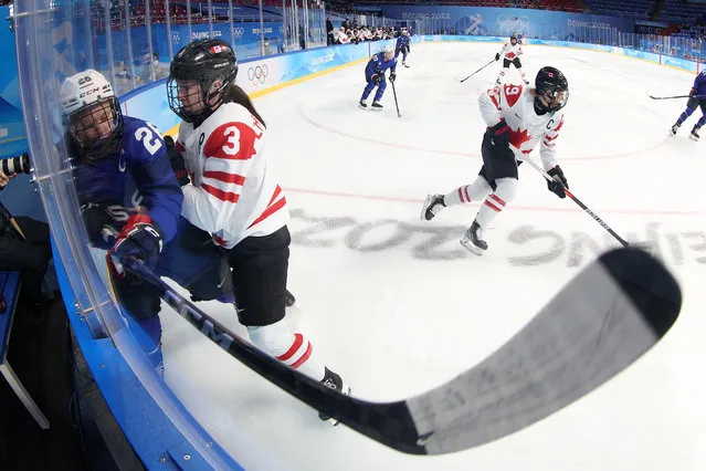 Jocelyne Larocque #3 of Team Canada checks Kendall Coyne Schofield #26 of Team United States in the corner boards in the first period during the Group A Women's Preliminary Round ice hockey match between Team United States and Team Canada at Wukesong Sports Centre on February 08, 2022 in Beijing, China. (Photo by Bruce Bennett/Getty Images)