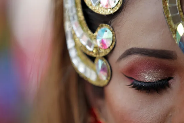 A participant waits to take part in a gay pride parade in Kathmandu, Nepal, Friday, August 16, 2019. Hundreds of lesbians, gays, bisexuals and transgenders paraded through Nepal's capital Friday to demand an end to discrimination against sexual minorities. Nepal is considered a conservative nation, most of its people are Hindu, and many still follow traditional beliefs. (Photo by Niranjan Shrestha/AP Photo)