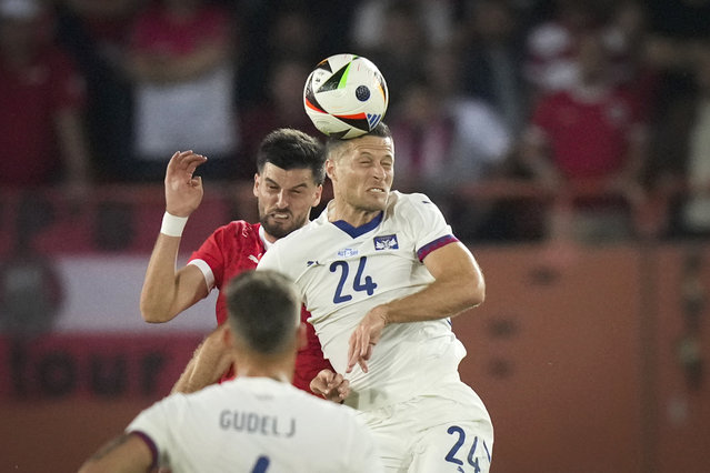 Austria's Florian Grillitsch, left, challenges for the ball with Serbia's Uros Spajic during an international friendly soccer match between Austria and Serbia at the Ernst Happel Stadion in Vienna, Austria, Tuesday, June 4, 2024. (Photo by Matthias Schrader/AP Photo)