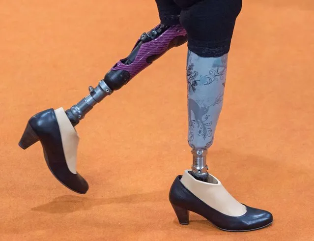 A woman walks with prostheses at the stand of US company Freedom inovations during the international trade show and world congress OTWorld in Leipzig, eastern Germany, Wednesday, May 4, 2016. At the centre of concerns are the product groups prosthetics, orthotics, orthopaedic footwear technology, compression therapy and rehabilitation. 542 exhibitors from 43 countries and trade and professional visitors from all over the world are coming to the fair. (Photo by Jens Meyer/AP Photo)