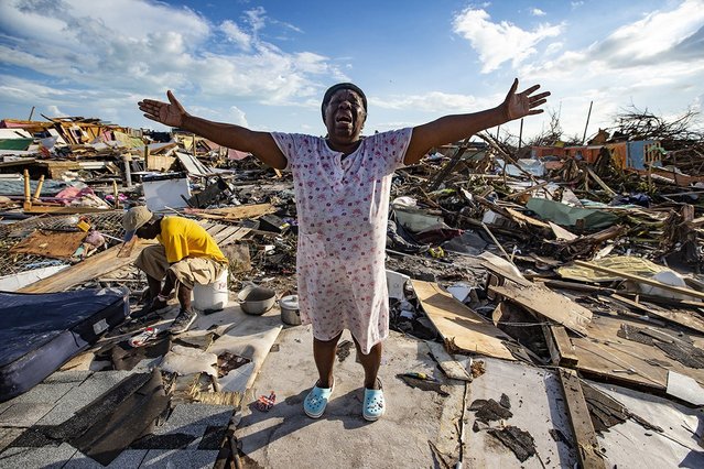 Aliana Alexis of Haiti stands on the concrete slab of what is left of her home after destruction from Hurricane Dorian in an area called “The Mud” at Marsh Harbour in Great Abaco Island, Bahamas on September 5, 2019. (Photo by Al Diaz/Zuma Press via AFP Photo)
