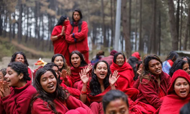 Nepali Hindu Devotees undergoing month long Swosthani Brata holds prayers ahead of the bathing ritual in the forest of Changu Narayan in Bhaktapur of Nepal as they ramp up the tradition of touring various religious places around Kathmandu Valley and Banepa on February 13, 2022. (Photo by Subash Shrestha/Rex Features/Shutterstock)