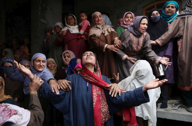 Relatives, friends and neighbors of slain 24-year-old girl Rafiya Nazir react during her funeral in Srinagar, India, 07 March 2022. Two people, including Rafiya Nazir, were killed and more than 30 others were injured when a grenade was thrown in the middle of the crowd at a busy market in Srinagar on 06 March 2022. (Photo by Farooq Khan/EPA/EFE)