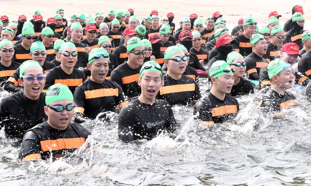 On July 22, 2024, the hottest day of the year, naval cadets are entering the water while singing the naval anthem, “Let's Go to the Sea”, in front of the Naval Academy in Changwon, Gyeongnam Province, during a maritime survival combat swimming training. (Photo by Kim Dong-hwan)