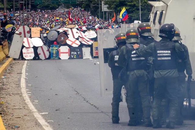 Opposition demonstrators clash with Bolivarian Guard in Caracas, Venezuela, 03 May 2017. Venezuela's Bolivarian National Guard (GNB) used tear gas to keep opposition demonstrations from reaching the center of the Venezuelan capital. (Photo by Miguel Gutierrez/EPA)