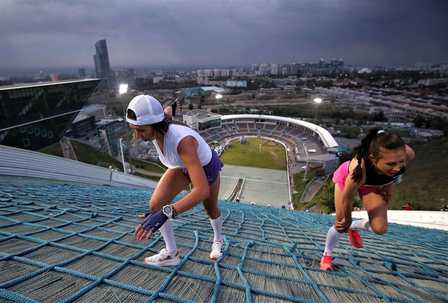 Athletes compete during the Red Bull 400 uphill sprint at the Sunkar International Ski Jumping Complex in Almaty, Kazakhstan on May 13, 2023. (Photo by Pavel Mikheyev/Reuters)