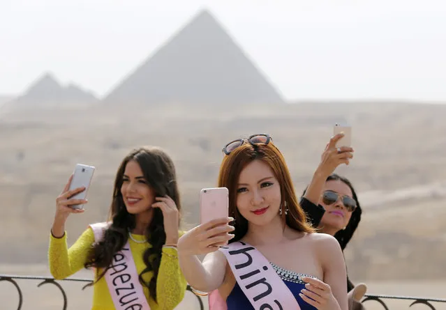 Contestants of Miss ECO Universe take a selfie with pyramids behind them on the outskirts of Cairo, Egypt, April 10, 2016. (Photo by Mohamed Abd El Ghany/Reuters)