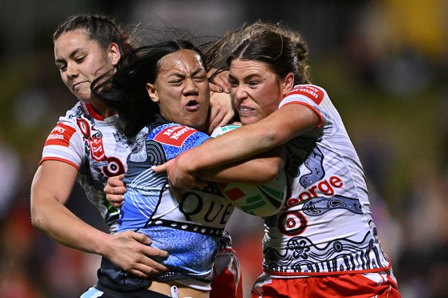 Alexis Tauaneai and Keele Browne of the St George Illawarra Dragons tackle Annessa Biddle of the Cronulla-Sutherland Sharks during a rugby league match at WIN Stadium in New South Wales, Australia on August 25, 2024. (Photo by James Gourley/AAP)