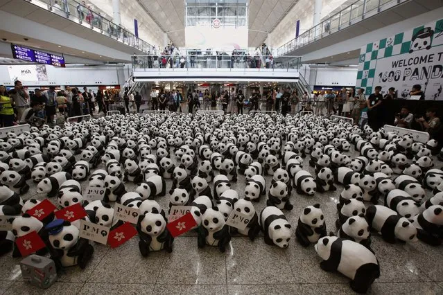 Papier-mache pandas, created by French artist Paulo Grangeon, are seen displayed at the arrival hall of the Hong Kong airport June 9, 2014. The installation arrived in the city on Monday, launching the month-long “1600 Pandas World Tour in Hong Kong: Creativity meets Conservation” organized by a local art organiser, according to the official press release. (Photo by Bobby Yip/Reuters)