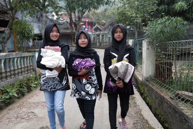 (L-R) Firdda Kurnia, Euis Siti Aisyah, and Widi Rahmawati, members of the metal hijab band Voice of Baceprot walk before they pray at a mosque in Garut, Indonesia, May 14, 2017. (Photo by Yuddy Cahya/Reuters)
