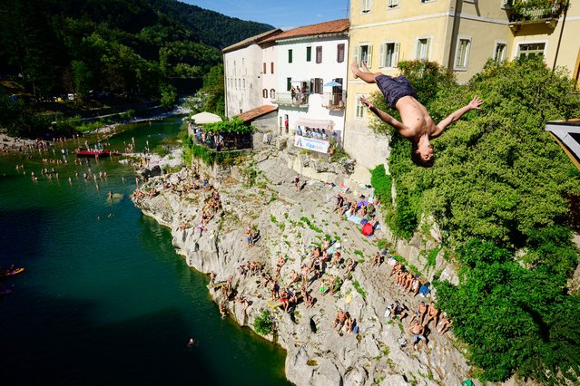 A diver jumps from a 17-meter-high bridge over the Soca river during a diving competition in Kanal, Slovenia, on August 11, 2024. (Photo by Jure Makovec/AFP Photo)