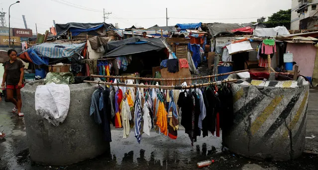 Laundry hangs between culverts used for flood control in Manila, Philippines May 25, 2016. (Photo by Erik De Castro/Reuters)