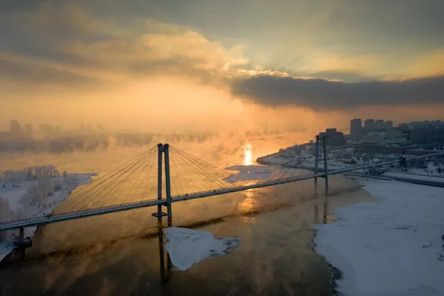 The Yenisei River within the city of Krasnoyarsk never freezes even in winter at minus 50 degrees due to the construction of the Krasnoyarsk hydroelectric power station upstream of the river. In severe frosts, the city is covered with strong evaporation from the surface of the water. (Photo by Alexander Manzyuk/Anadolu Agency via Getty Images)