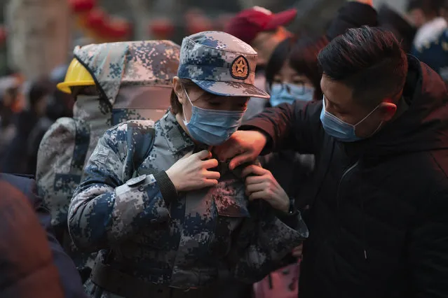In this photo taken January 24, 2020 and released by Xinhua News Agency, a military medic from the Air Force Medical University prepares to leave for Wuhan from Xi'an, capital of northwestern China's Shaanxi Province. The Chinese military dispatched medical staff, some with experience in past outbreaks including SARS and Ebola, to help treat the many patients hospitalized with viral pneumonia, Xinhua reported. (Photo by Zhang Haopeng/Xinhua via AP Photo)