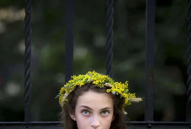 A girl dressed as a summer fairy attends an event inspired by pre-christian traditions in Bucharest, Romania, Friday, June 24, 2016. According to pre-christian traditions, fairies, called in Romanian “Sanziene”, come to earth around the summer solstice bringing fertility to land and beings for the coming summer. (Photo by Vadim Ghirda/AP Photo)