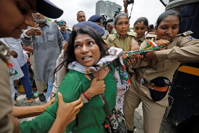 A supporter of India's main opposition Congress reacts as she is detained by police during a protest after the party leader Rahul Gandhi was summoned by the Enforcement Directorate in a money laundering case, in Ahmedabad, India, June 13, 2022. (Photo by Amit Dave/Reuters)