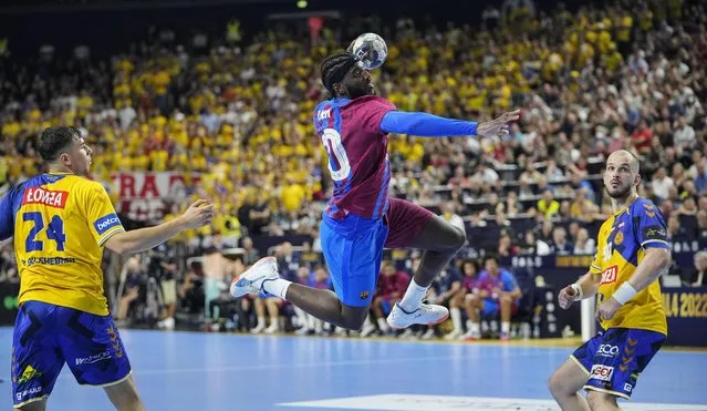 Barcelona's Dika Mem jumps to score during the Final Four Champions League handball final match between Lomza Vive Kielce and FC Barcelona in Cologne, Germany, Sunday, June 19, 2022. (Photo by Martin Meissner/AP Photo)