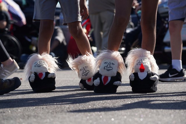 Two kids wear slippers depicting Republican presidential nominee and former President Donald Trump ahead of a campaign stop called Believers and Ballots Faith Town Hall at Christ Chapel in Zebulon, Georgia on October 23, 2024. (Photo by Megan Varner/Reuters)