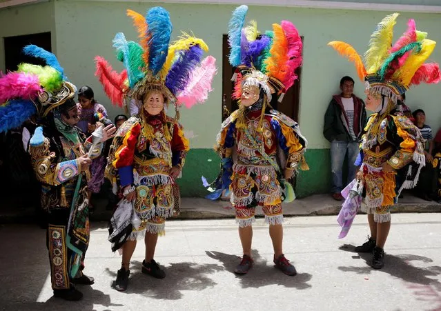 Dancers dressed for the annual procession honoring San Pedro, their town's patron saint, wait along the streets of San Pedro Sacatepequez near Guatemala City June 29, 2016. (Photo by Saul Martinez/Reuters)