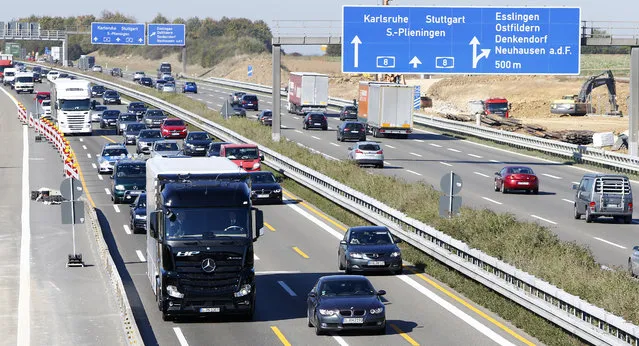 An Actros autonomous truck by Mercedes-Benz (L),  equipped with the intelligent Highway Pilot system, conducts its first drive along public highway A8 between Denkendorf and Stuttgart, Germany, 2015. (Photo by Michaela Rehle/Reuters)