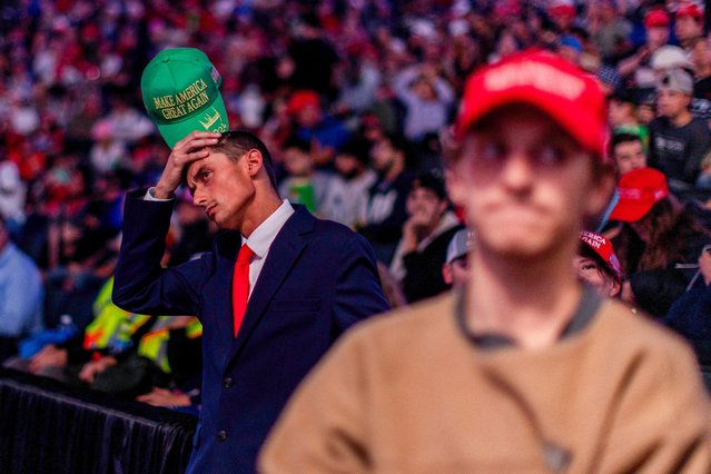 People wait inside the venue where Donald Trump is expected to hold a campaign rally in Grand Rapids, Michigan on November 4, 2024. (Photo by Carlos Osorio/Reuters)