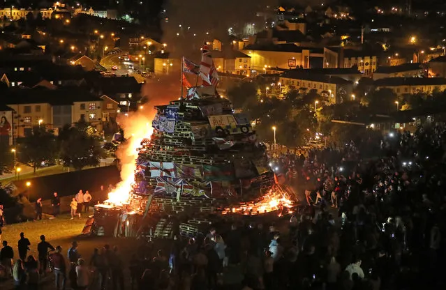A bonfire in the bogside area, which is traditionally torched on August 15 in Londonderry, Northern Ireland to mark a Catholic feast day celebrating the assumption of the Virgin Mary into heaven, but in modern times the fire has become a source of contention and associated with anti-social behaviour. (Photo by Niall Carson/PA Wire)