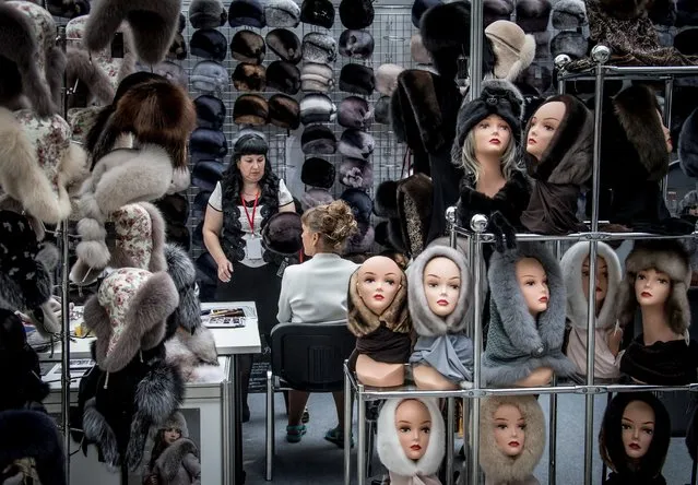 A vendor presents a collection of fur hats during the international fashion fair Chapeau & Mosfur 2017 in Moscow on August 17, 2017. (Photo by Mladen Antonov/AFP Photo)