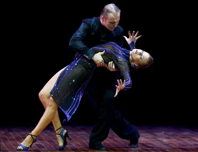 Stanislav Fursov (top) and Ekaterina Simonova from Russia, who are representing the city of Moscow, dance during the Stage style final round at the Tango World Championship in Buenos Aires, Argentina, August 27, 2015. (Photo by Marcos Brindicci/Reuters)