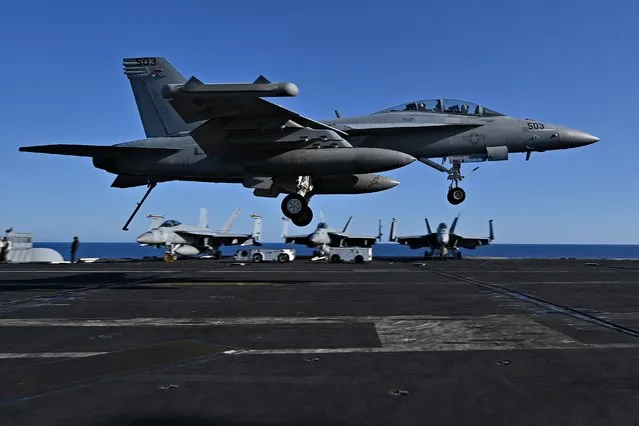 An F/A-18 Hornet fighter jet landing on the deck of the US Nimitz-class nuclear-powered aircraft carrier USS Harry S. Truman, during a NATO vigilance activity NEPTUNE SHIELD 2022 (NESH22) on eastern Mediterranean Sea on May 23, 2022. NATO is conducting vigilance activity NEPTUNE SHIELD 2022 (NESH22), which integrates high-end maritime expeditionary strike capabilities of Sea, Air and Land assets. The activities are take place in the Baltic, Adriatic and Mediterranean Seas, from 17-31 May. The already planned participating nations are: Albania, Bulgaria, Croatia, Denmark, France, Germany, Greece, Italy, Latvia, Lithuania, Netherlands, Poland, Portugal, Romania, Slovenia, Spain, Turkey, the U.K. and the U.S. (Photo by Andreas Solaro/AFP Photo)