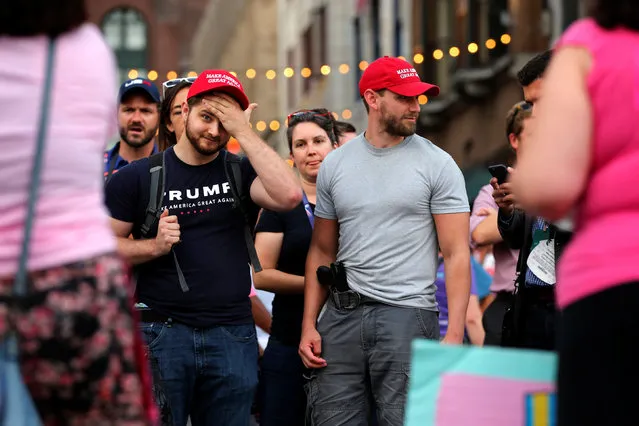 Trump supporters, including one carrying a handgun, listen to  “Code Pink” protesters outside of the Republican National Convention in Cleveland, Ohio, U.S., July 18, 2016. (Photo by Lucas Jackson/Reuters)