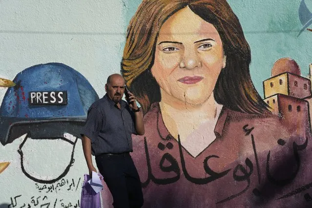 A mural of slain of Al Jazeera journalist Shireen Abu Akleh is on display, in Gaza City, Sunday, May 15, 2022. Abu Akleh was shot and killed while covering an Israeli raid in the occupied West Bank town of Jenin on May 11, 2022. (Photo by Adel Hana/AP Photo)