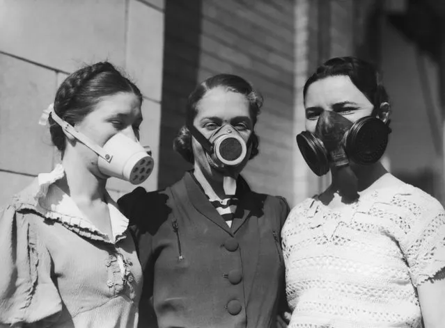 Three girls modelling various dustbowl masks to be worn in areas where the amount of dust in the air causes breathing difficulties, circa 1935. (Photo by Bert Garai/Keystone/Hulton Archive/Getty Images)