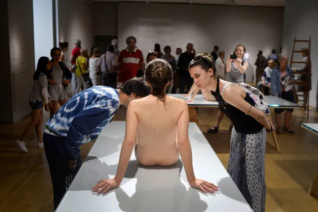 Visitors observe the sculpture “That Girl” by U.S. artist Paul McCarthy, at the Hyperrealist Sculpture 1973-2016 exhibition in the Museum of Bellas Artes in Bilbao, northern Spain, July 27, 2016. (Photo by Vincent West/Reuters)