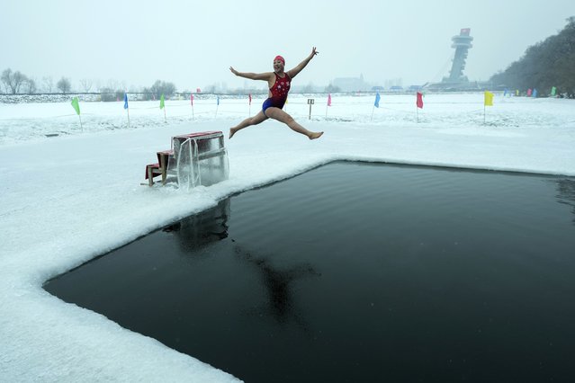 Yu Xiaofeng leaps as she jumps into a pool carved from ice on the frozen Songhua river in Harbin in northeastern China's Heilongjiang province, Tuesday, January 7, 2025. (Photo by Andy Wong/AP Photo)