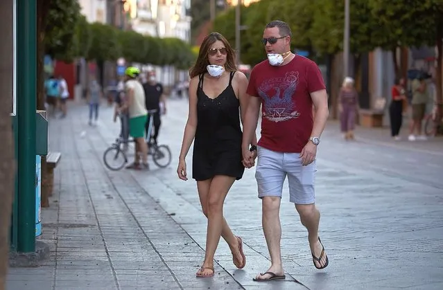 People are seen walking on May 02, 2020 in Seville, Spain. Spain has started to ease the Coronavirus Covid-19 lockdown measures on a high temperatures weekend, with walking with the family, outdoor exercise like running and going out with children now allowed in the whole country. (Photo by Fran Santiago/Getty Images)