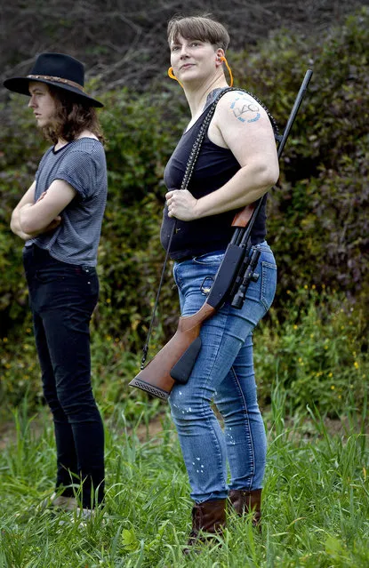 In this October 8, 2017, photo, Lore McSpadden, right, and Jon Dumont wait to shoot at clay targets during a training session for the Trigger Warning Queer & Trans Gun Club in Victor, N.Y. (Photo by Adrian Kraus/AP Photo)