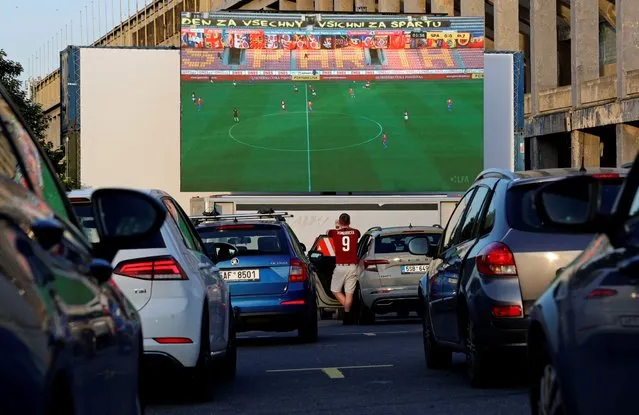 Fans watch a soccer match between Sparta Prague and Viktoria Plzen at a drive-in cinema, as the Czech top-tier soccer competition resumes after a two-month shutdown caused by the measures taken to curb the coronavirus disease (COVID-19) outbreak in Prague, Czech Republic, May 27, 2020. (Photo by David W. Cerny/Reuters)