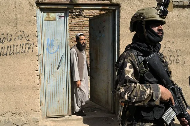 Taliban fighters stand guard in front of an education center that was attacked by a suicide bomber, in Kabul, Afghanistan, Friday, September 30, 2022. A Taliban spokesman says a suicide bomber has killed several people and wounded others at an education center in a Shiite area of the Afghan capital. The bomber hit while hundreds of teenage students inside were taking practice entrance exams for university, a witness says. (Photo by Ebrahim Noroozi/AP Photo)
