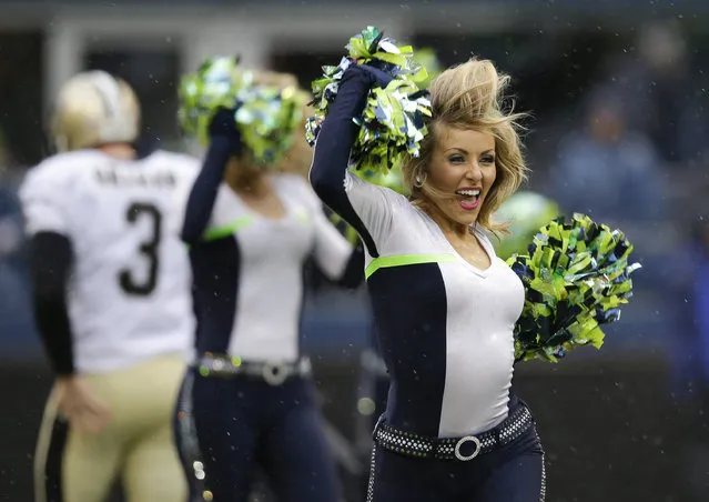Seattle Seahawks Sea Gals cheerleaders perform before an NFC divisional playoff NFL football game against the New Orleans Saints in Seattle, Saturday, January 11, 2014. (Photo by Elaine Thompson/AP Photo)