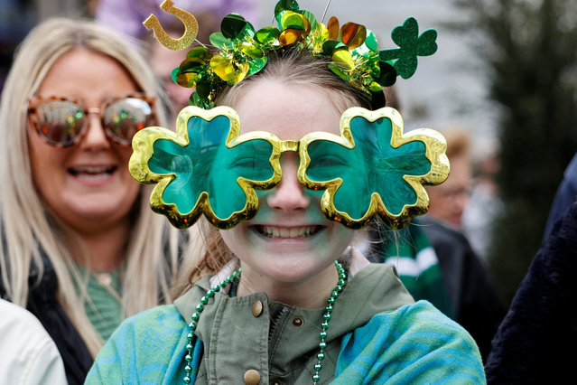 A girl wears glasses in the shape of shamrocks on the day of St Patrick's Festival in London, on March 16, 2025. (Photo by Carlos Jasso/Reuters)