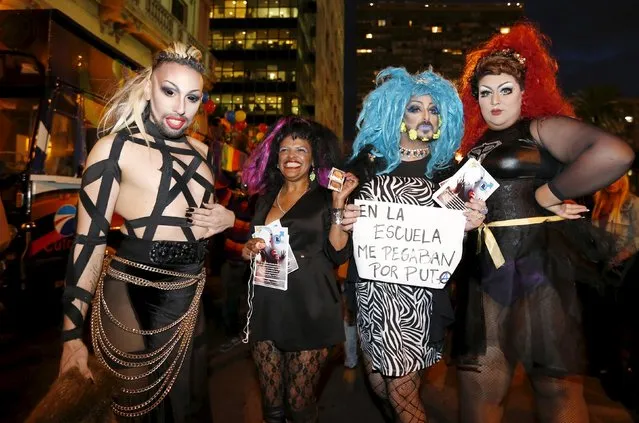 Revellers participate in the "Marcha de la diversidad" (diversity demonstration) in downtown Montevideo September 25, 2015. Members of the lesbian, gay, bisexual and transgender (LGBT) community and residents took part in the annual parade. The sign reads, "I was hit at school for being a fag". (Photo by Andres Stapff/Reuters)