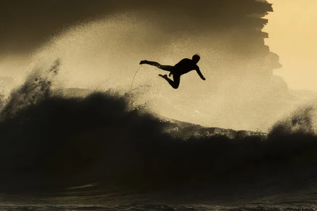 A surfer is seen falling from his board at Bronte Beach on July 21, 2020 in Sydney, Australia. 13 new COVID-19 cases have been confirmed in NSW on Tuesday, with residents across the state encouraged to wear face masks where social distancing is difficult to maintain to help reduce the further spread of coronavirus. (Photo by Jenny Evans/Getty Images)