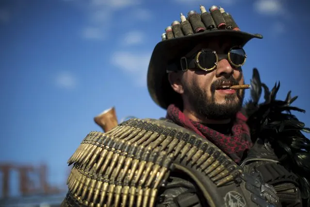 Enthusiast Mike Kemling, dressed as "Wasteland Ranger," poses for a portrait during Wasteland Weekend event in California City, California September 26, 2015. The four-day event has a post-apocalyptic theme and is inspired by the Mad Max movie franchise. (Photo by Mario Anzuoni/Reuters)